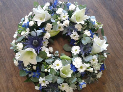 Blue and white wreath - Classic Wreath with Blue and White Flowers.This classic wreath an elegant mix of blue and white seasonal  flowers designed by our expert florists. A perfect tribute to say your final farewell to a loved one, friend or colleague. If you have a specific request to be included in this wreath please place a note on your order or alternatively you speak directly to one of our florists on 0191 2522553 are opening hours are Monday to Friday 9.00 to 5.30 or email us at sales@thegardenshopflorist.com...